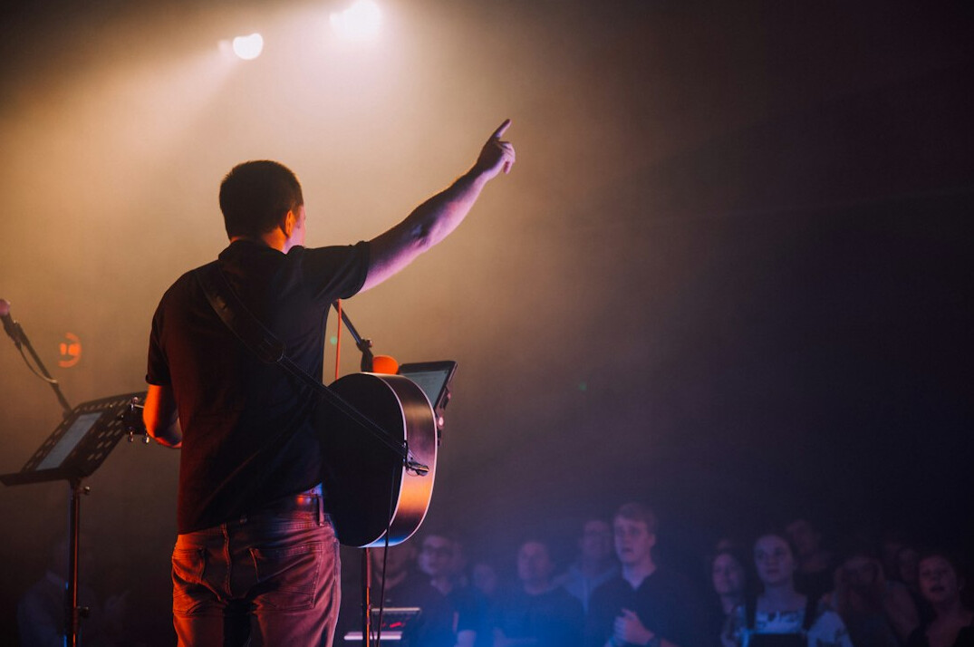 Speaker on stage presenting to an audience