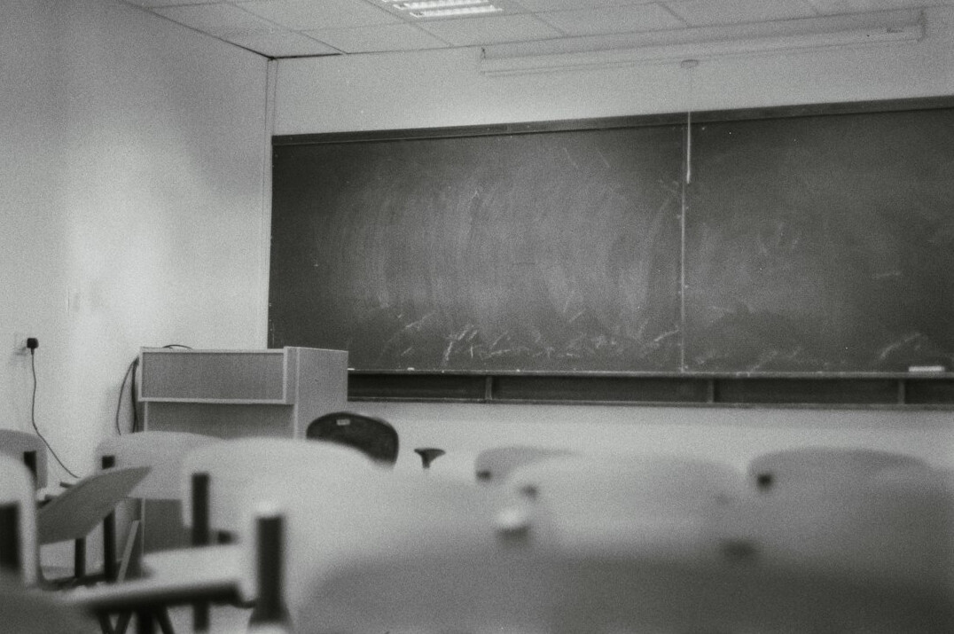 Instructor presenting to a small group in a bright classroom